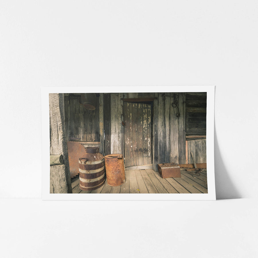Porch at Leichhardt House, a covered timber verandah, grey and split with age.