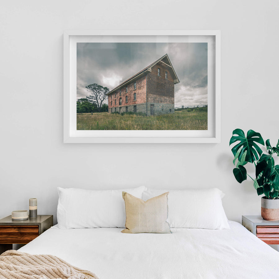 End of the Mill at Mill Pond Farm, a two-storey brick and bluestone building stands alone in open grassland.