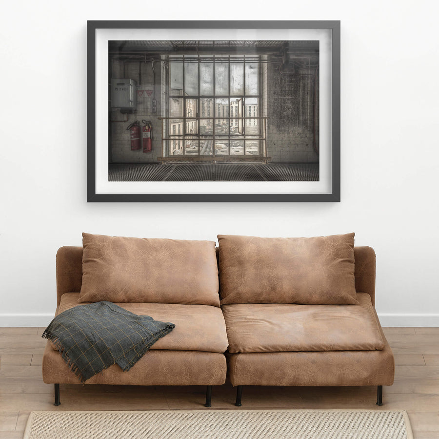 B to A at Morwell Power Station, a steel-framed window stretches floor to ceiling, divided into a grid of thick panes.