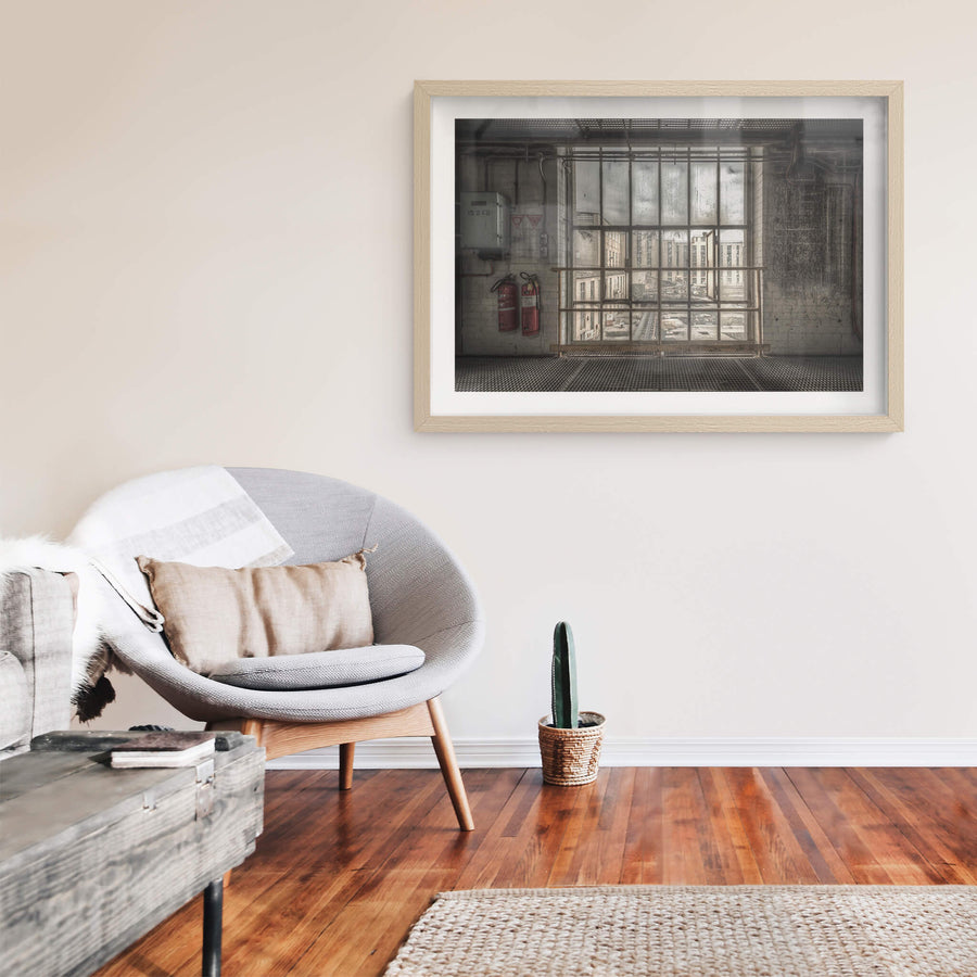 B to A at Morwell Power Station, a steel-framed window stretches floor to ceiling, divided into a grid of thick panes.