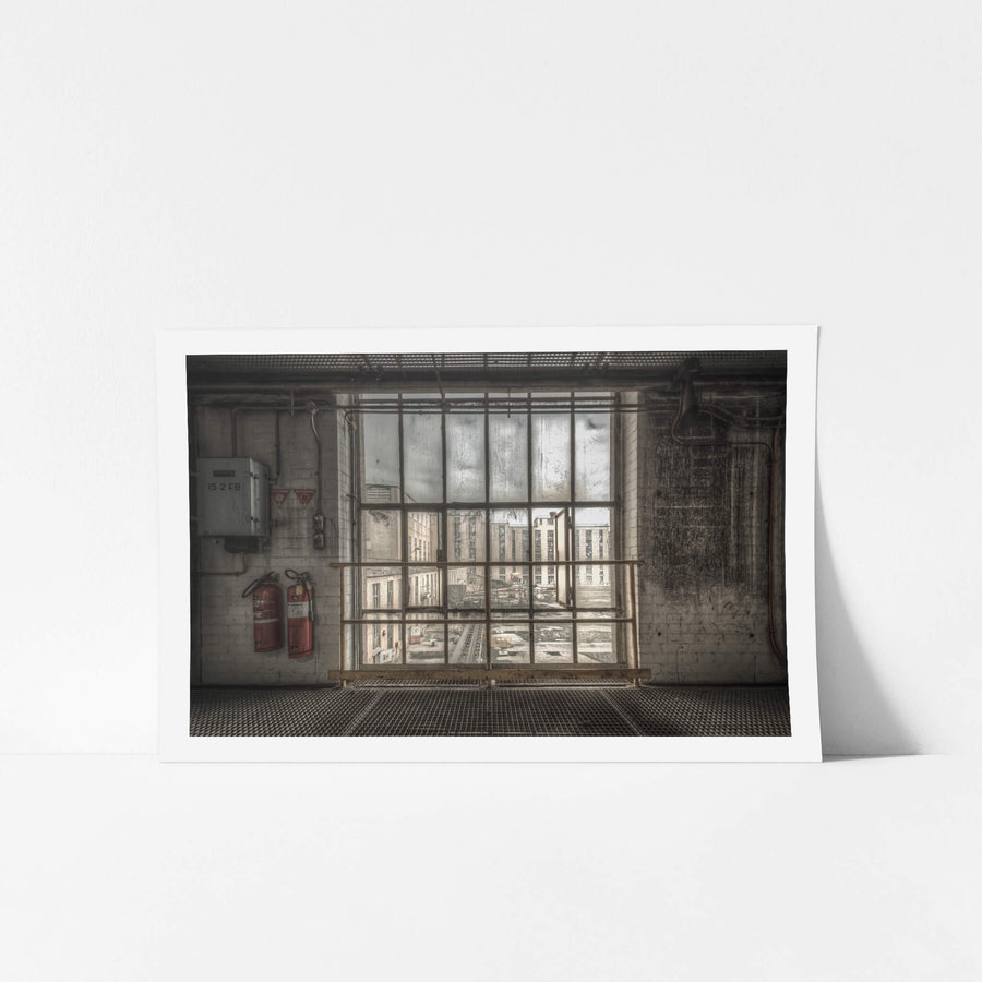 B to A at Morwell Power Station, a steel-framed window stretches floor to ceiling, divided into a grid of thick panes.