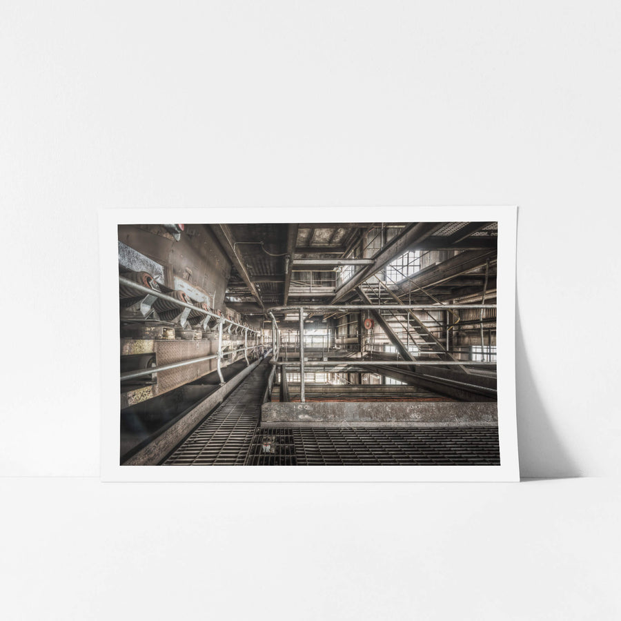 Shuttle Conveyor at Morwell Power Station, a steel grating walkway runs alongside a heavy conveyor system deep inside.