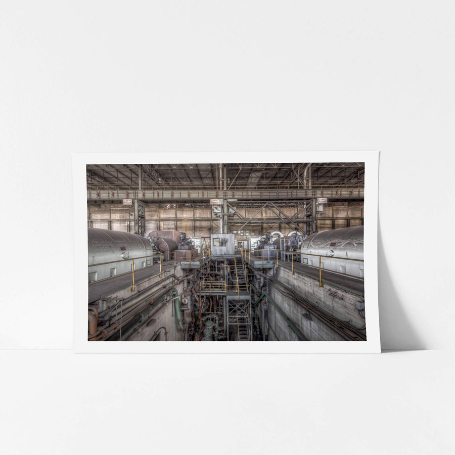 Turbine Floor at Morwell Power Station, four turbo-alternator units sit in two rows, their cylindrical steel casings grey.