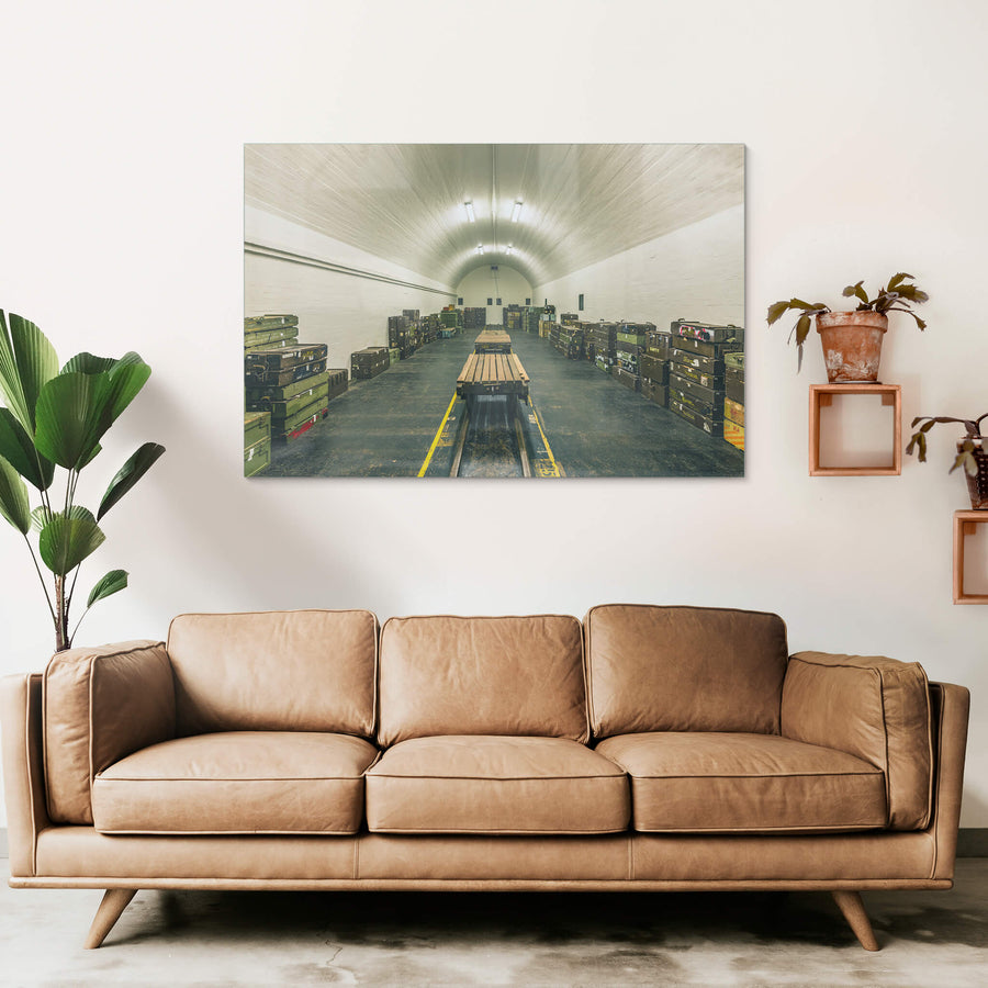 Magazine Interior at Newington Armory, a barrel-vaulted ceiling of whitewashed brick curves over rows of military ordnance.
