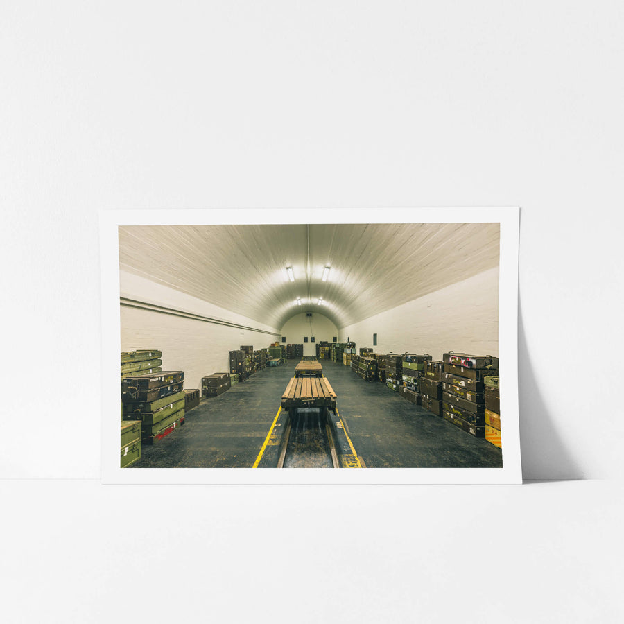 Magazine Interior at Newington Armory, a barrel-vaulted ceiling of whitewashed brick curves over rows of military ordnance.