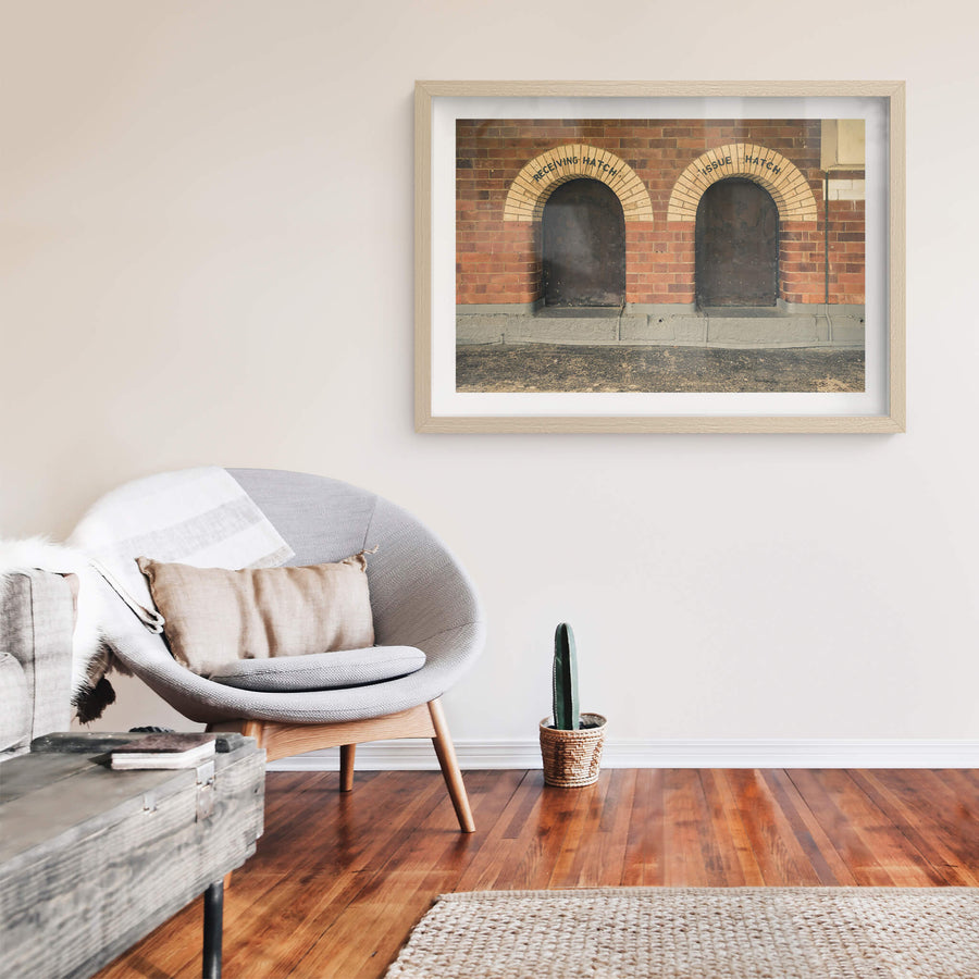 Recieving Issue at Newington Armory, two arched hatches sit side by side in a red brick wall.