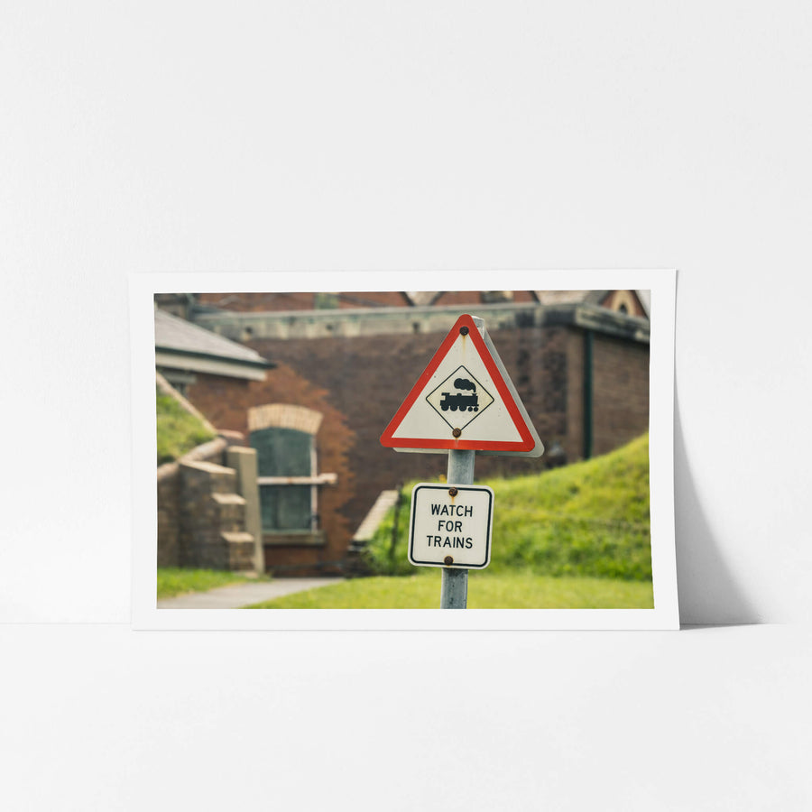 Watch For Trains at Newington Armory, a triangular rail crossing sign stands on a galvanised steel post.