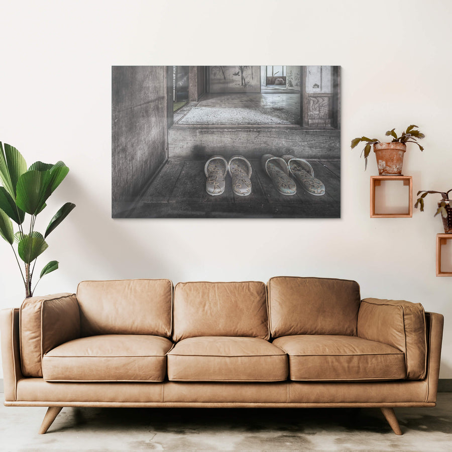 Genkan at Nichitsu Mining Village, two pairs of slippers sit on the worn timber floor of a genkan, their floral fabric.