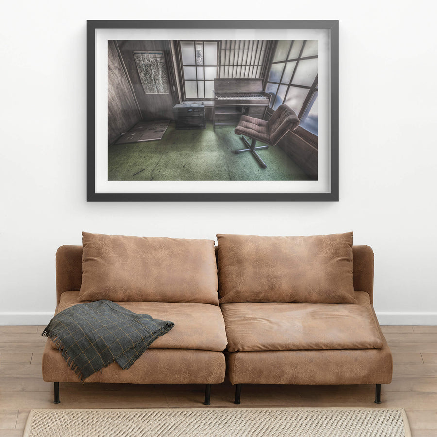 Studio at Nichitsu Mining Village, a plaid swivel chair faces a compact electric organ in the corner of a small.