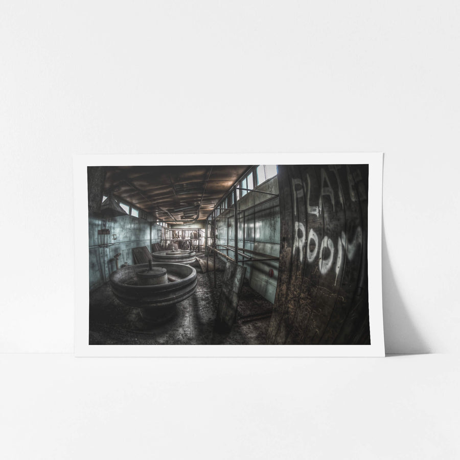 Plate Room at O-I Glass, large circular vats sit low on a wet concrete floor.