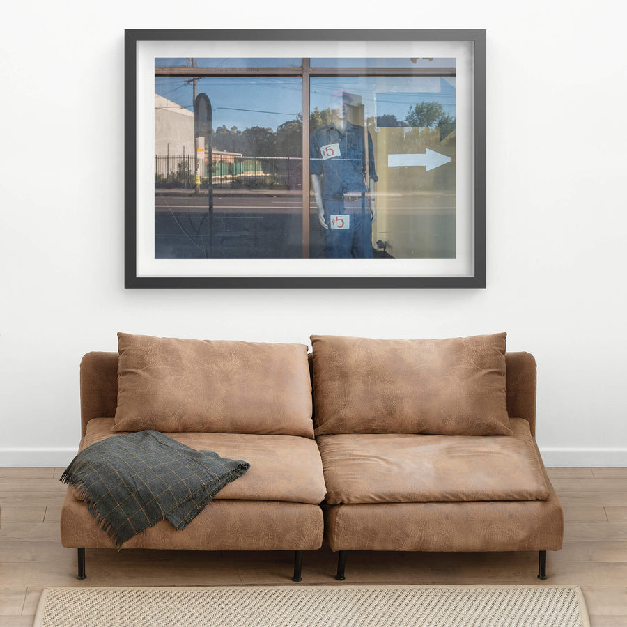 10 Dollar Look at Parramatta Road, a mannequin stands behind plate glass in a closed shopfront on Parramatta Road.
