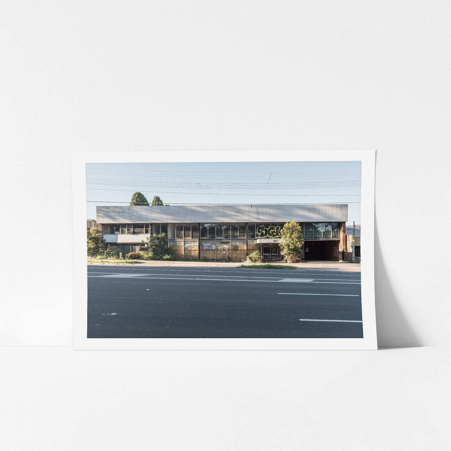 187 at Parramatta Road, a two-storey commercial building sits hard against Parramatta Road.