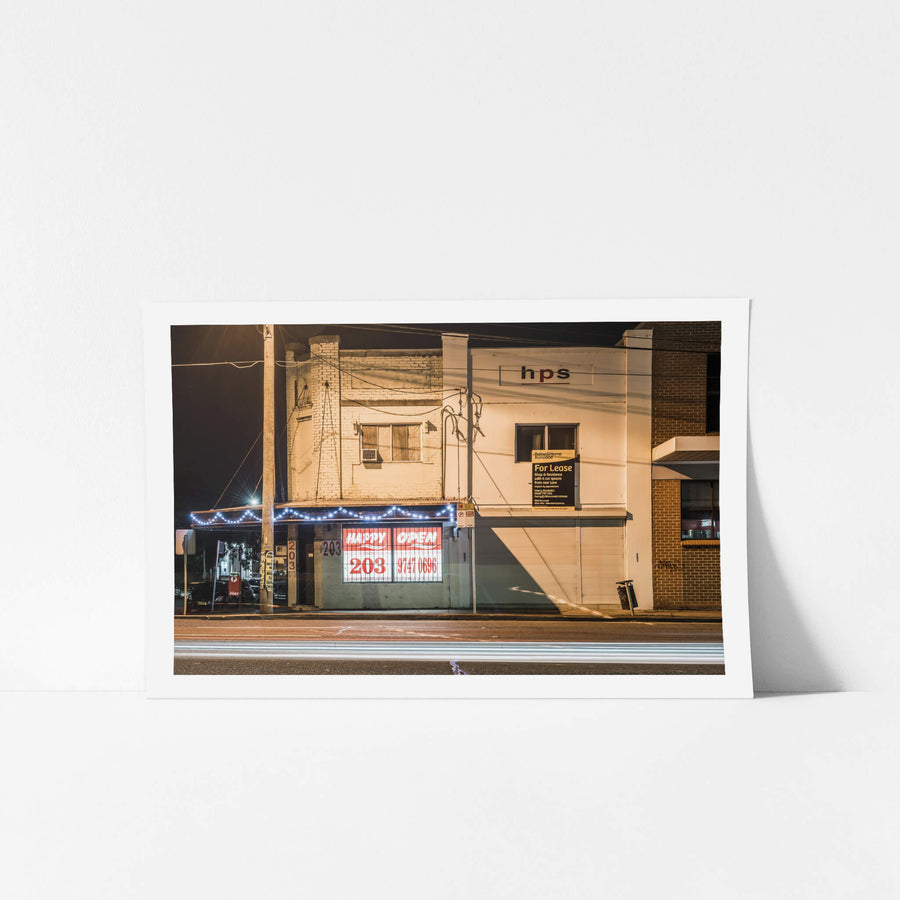 Happy 203 at Parramatta Road, a two-storey shopfront at 203 Parramatta Road, painted white over old brickwork.