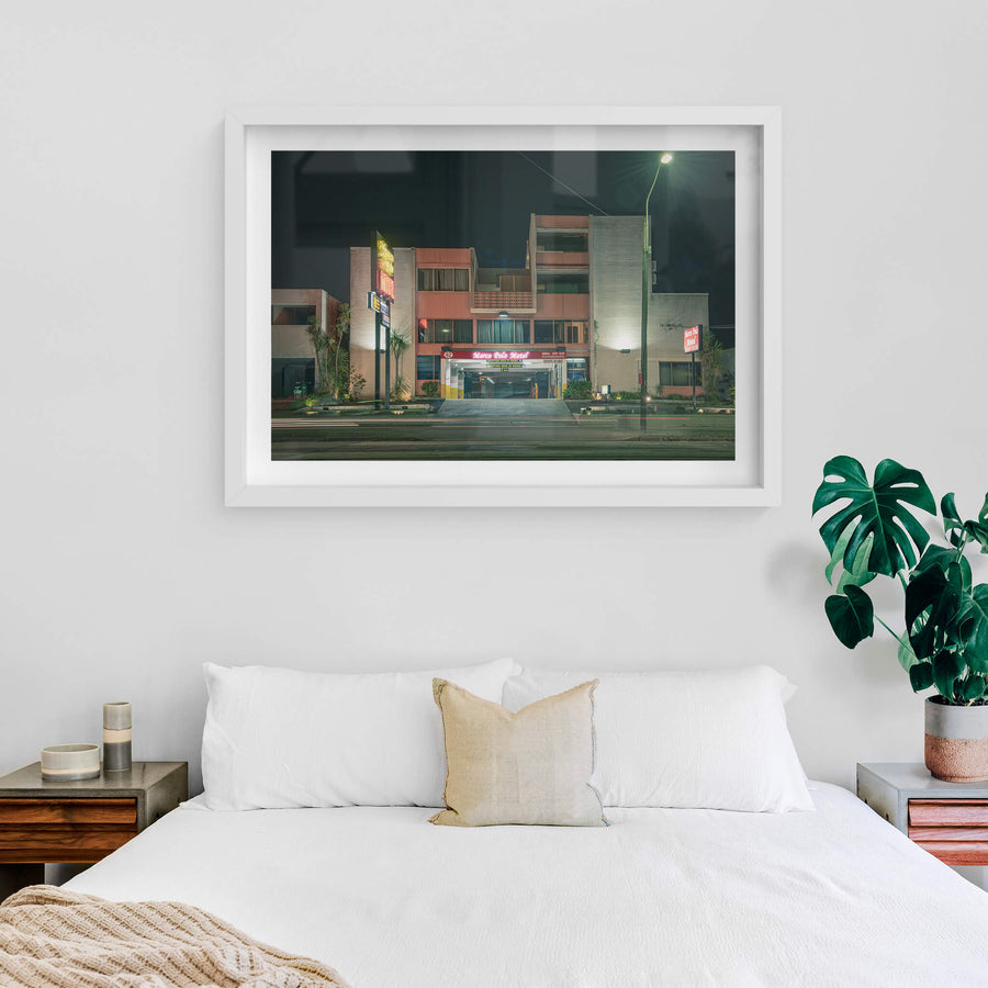 Marco Polo Motel at Parramatta Road, three storeys of grey brick columns frame open balconies with decorative breezeblock.