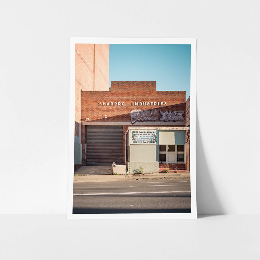 Sharpro Industries at Parramatta Road, white block lettering runs across the upper brickwork.