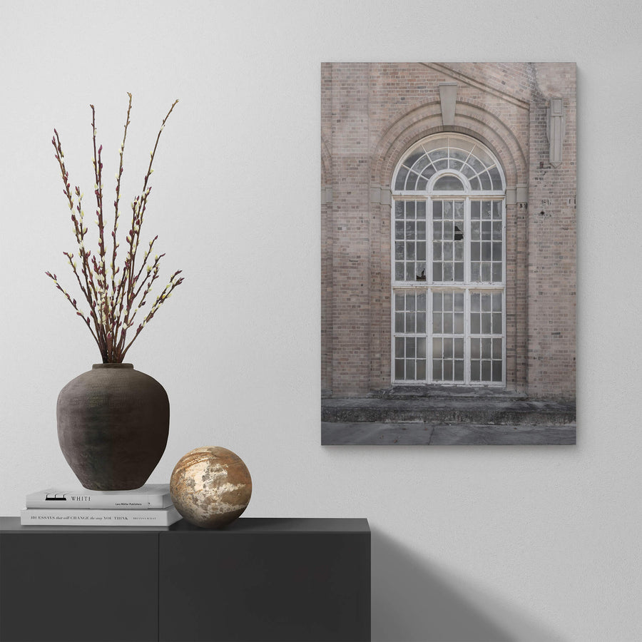 Arched Window at Portland Cement Works, a tall arched window set deep into a brick facade.