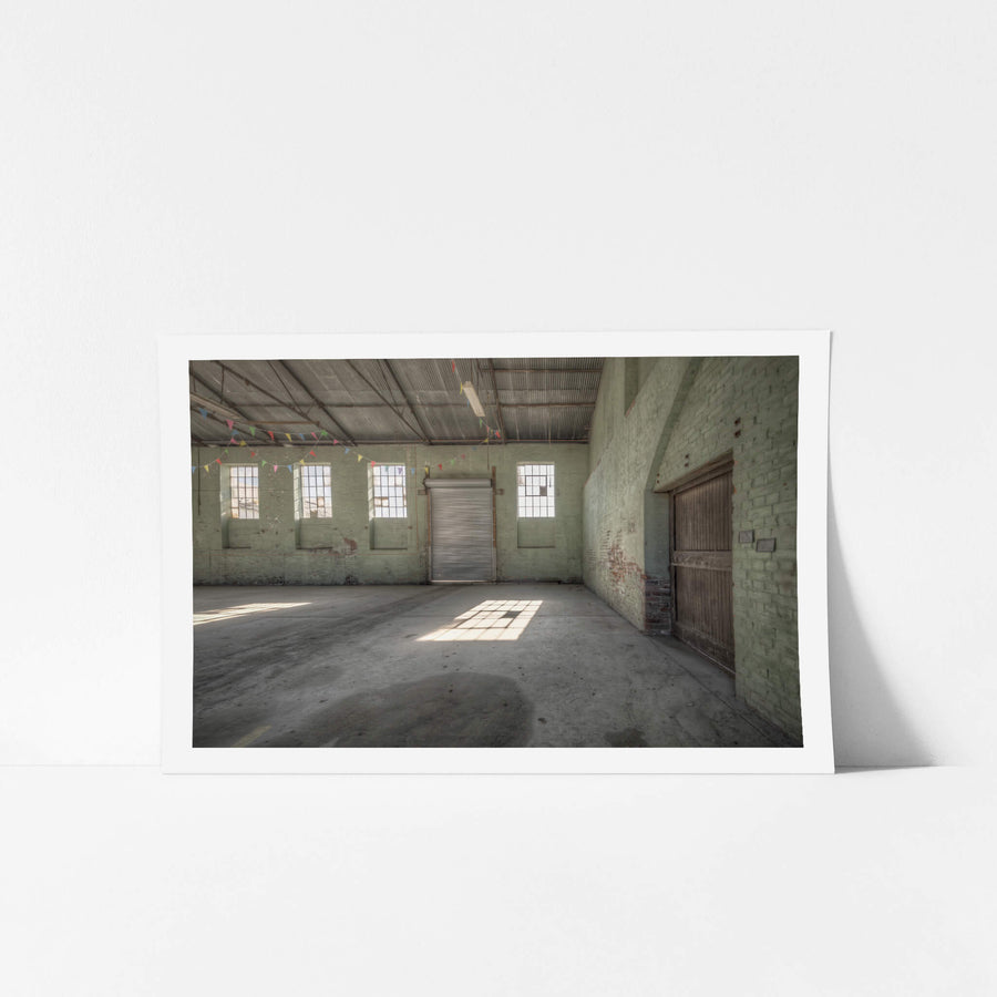 Boiler House Wall at Portland Cement Works, pale green brick walls rise to a corrugated iron roof supported by steel trusses.
