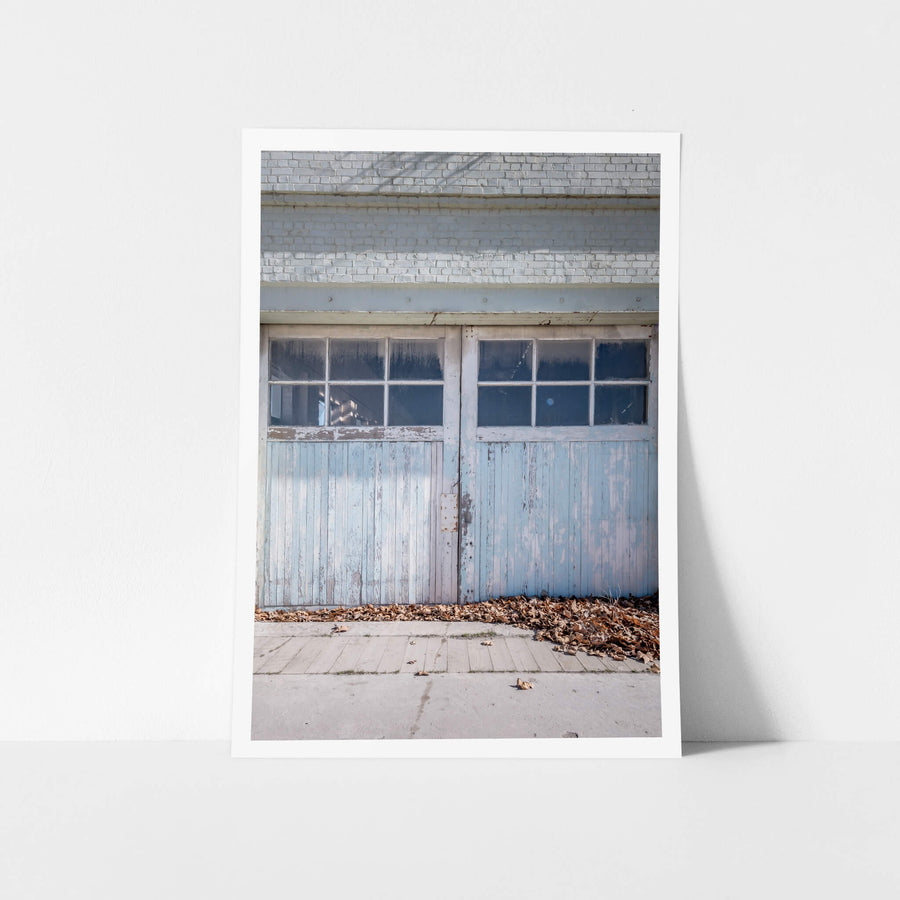 Machine Shop Door at Portland Cement Works, a pair of timber doors sit flush against a pale brick facade.