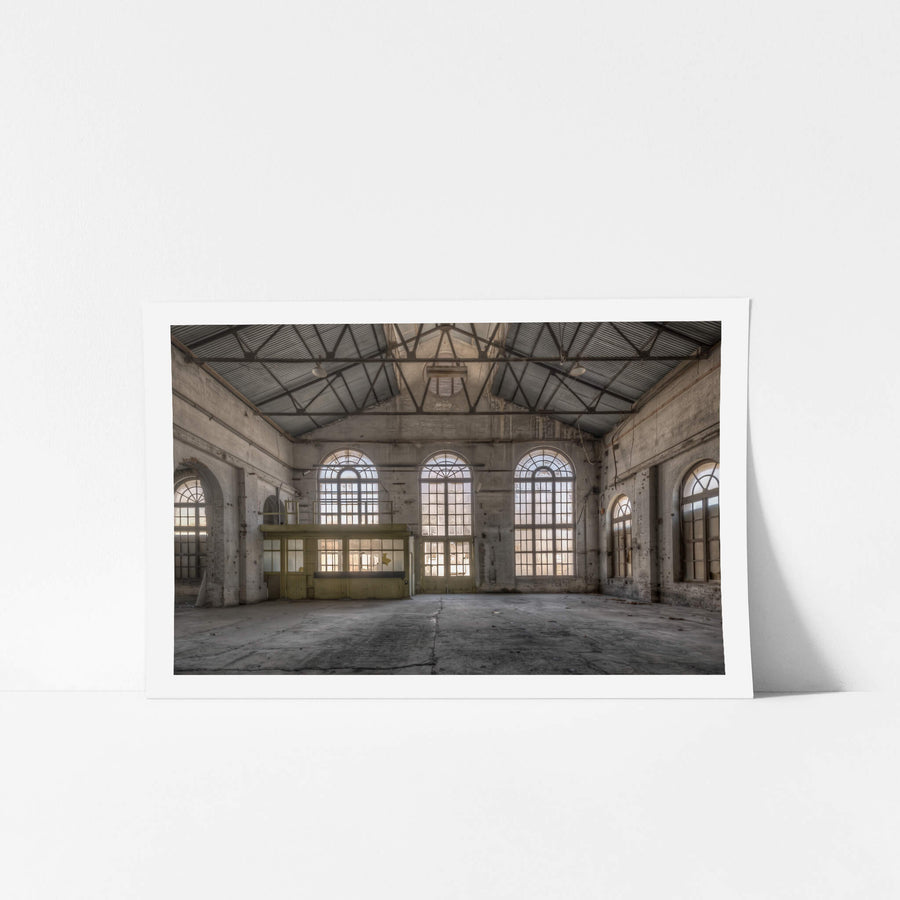 Power House Southern Interior at Portland Cement Works, light floods through five arched windows set into a concrete wall.