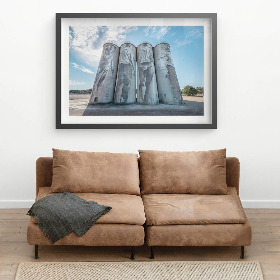 Silos at Portland Cement Works, four concrete silos stand in a row against open sky.
