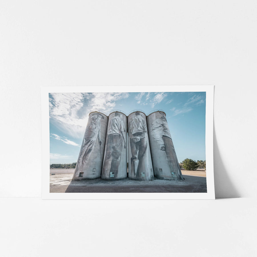 Silos at Portland Cement Works, four concrete silos stand in a row against open sky.