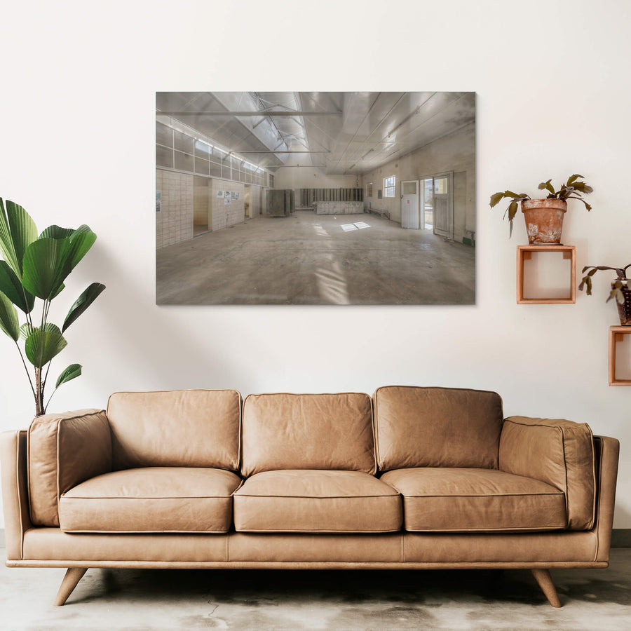 Wash House Facing West at Portland Cement Works, light falls through clerestory windows and cuts across the concrete floor.