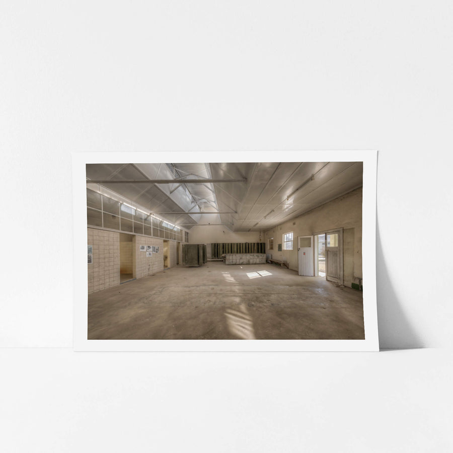 Wash House Facing West at Portland Cement Works, light falls through clerestory windows and cuts across the concrete floor.