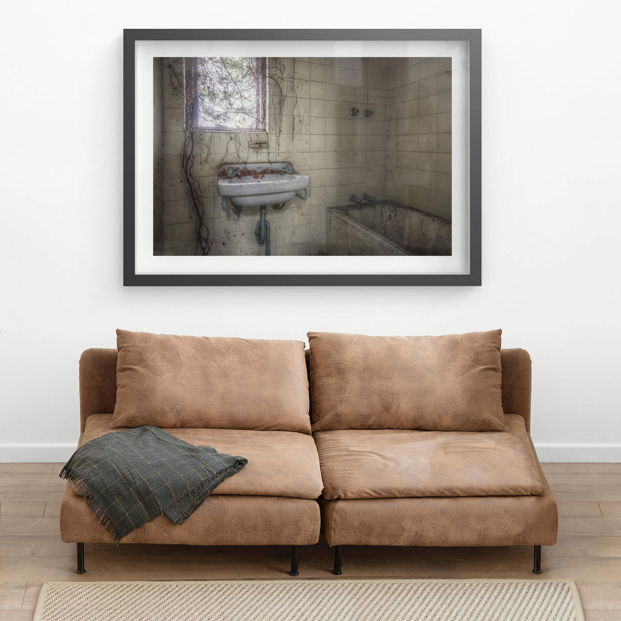 Bathroom at Terminus Hotel, dust clings to every surface, settling thick across the enamel of the hand basin.