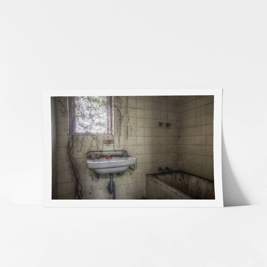 Bathroom at Terminus Hotel, dust clings to every surface, settling thick across the enamel of the hand basin.
