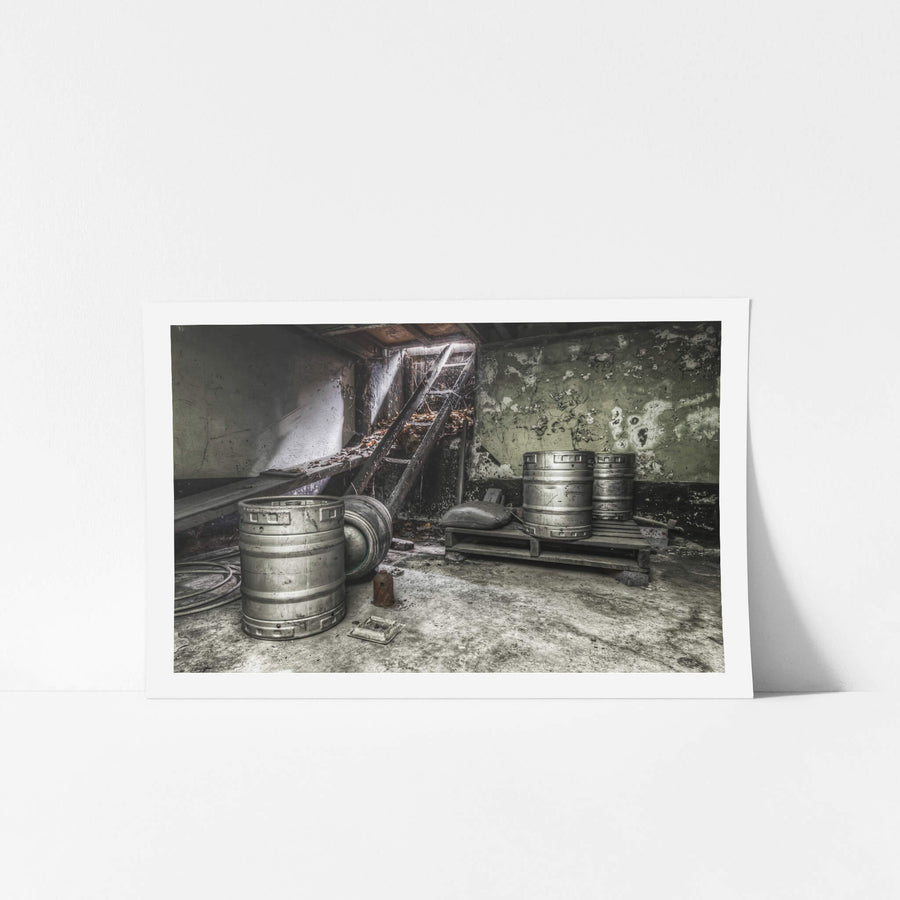 Cellar at Terminus Hotel, three stainless steel beer kegs sit on a concrete floor.