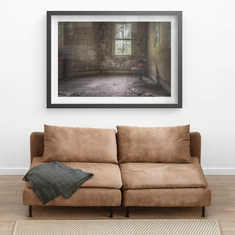 The World's Loneliest Chair at Terminus Hotel, a single red chair sits in the corner of an otherwise empty room of Terminus.
