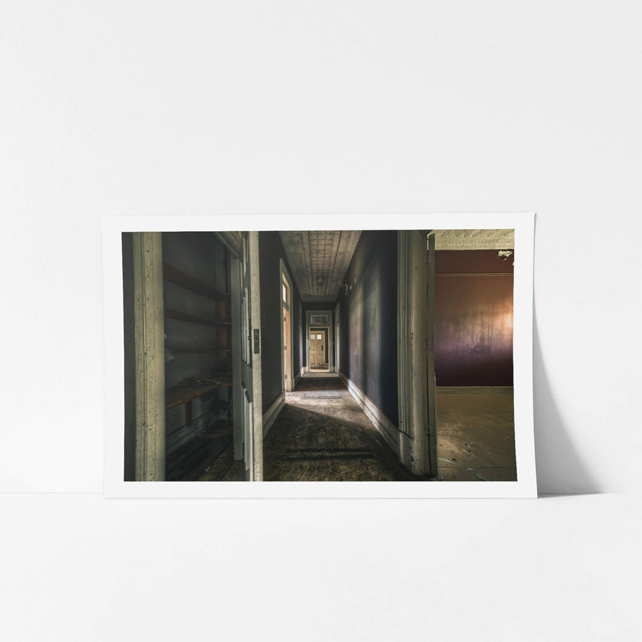 Beyond the Closet at The Asylum, a narrow hallway runs deep into the building, terminating at a closed timber door.