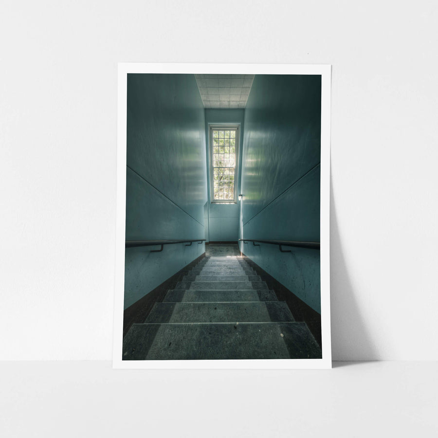 Blue Descent at The Asylum, a narrow stairwell descends between teal-painted walls.