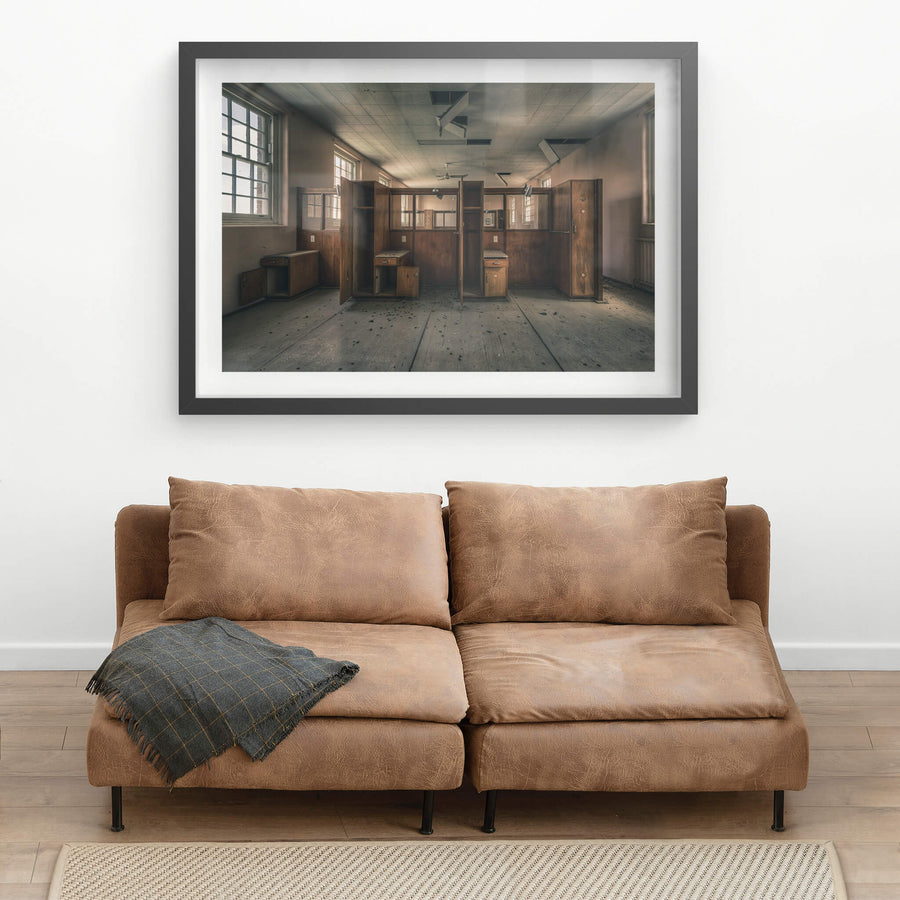Divide at The Asylum, timber wardrobes and bedside cabinets stand open in two rows, dividing the room into narrow cubicles.