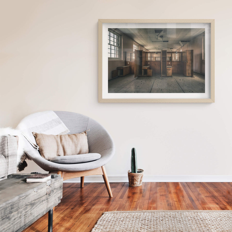 Divide at The Asylum, timber wardrobes and bedside cabinets stand open in two rows, dividing the room into narrow cubicles.