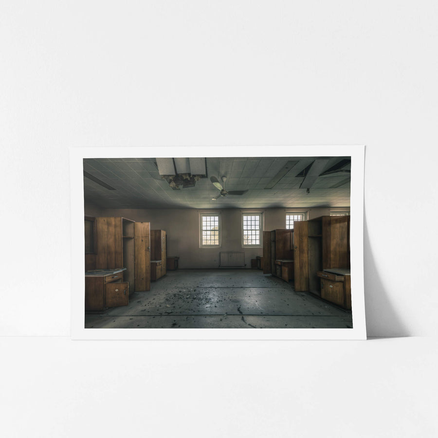 Down the Middle at The Asylum, timber wardrobes line both walls in symmetrical rows, their doors hanging open, shelves bare.