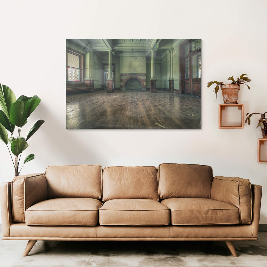 Fireplace at The Asylum, a wide formal room with pale green walls and coffered ceilings.