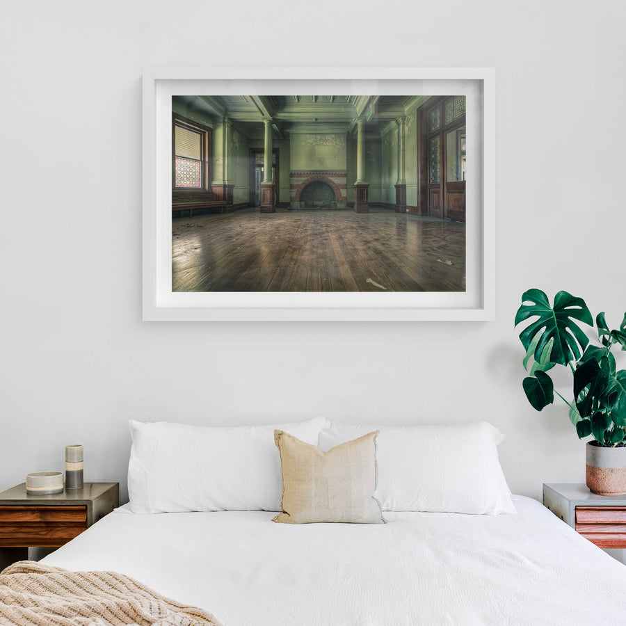 Fireplace at The Asylum, a wide formal room with pale green walls and coffered ceilings.