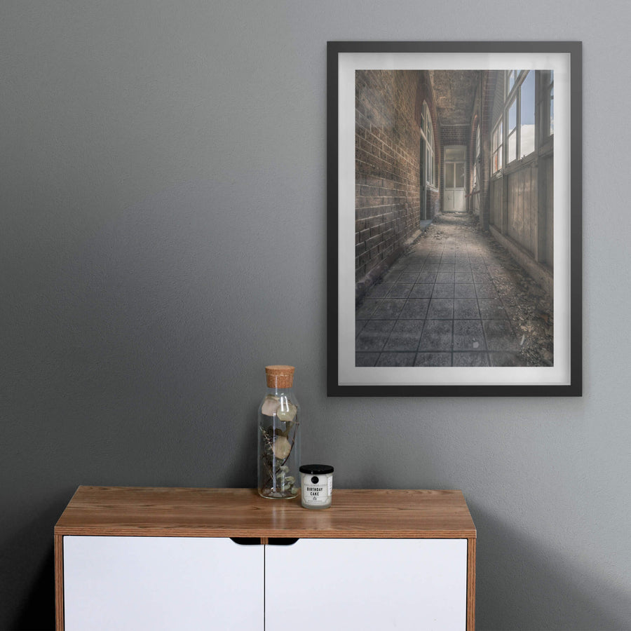 In Between at The Asylum, a narrow corridor runs between a brick wall and a timber-panelled enclosure.