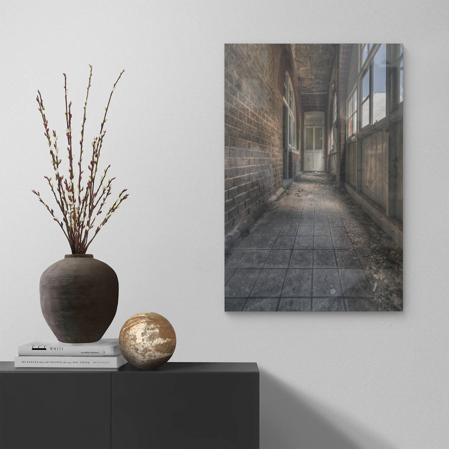 In Between at The Asylum, a narrow corridor runs between a brick wall and a timber-panelled enclosure.