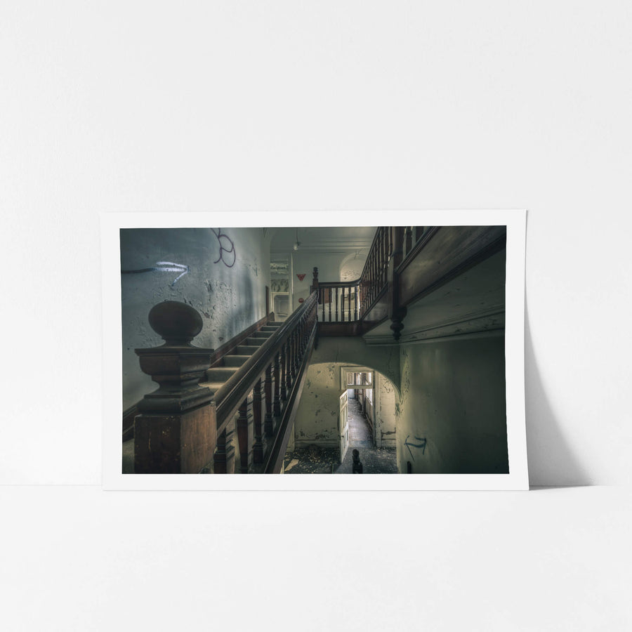 Intermission at The Asylum, a dark timber balustrade climbs through the centre of the stairwell, its turned spindles still.