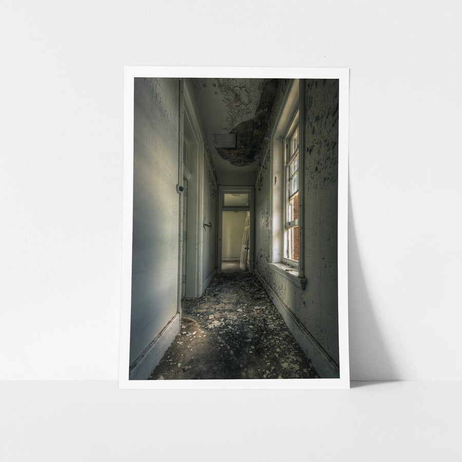 Mouldy Hall at The Asylum, a narrow corridor runs toward an open doorway at the far end.