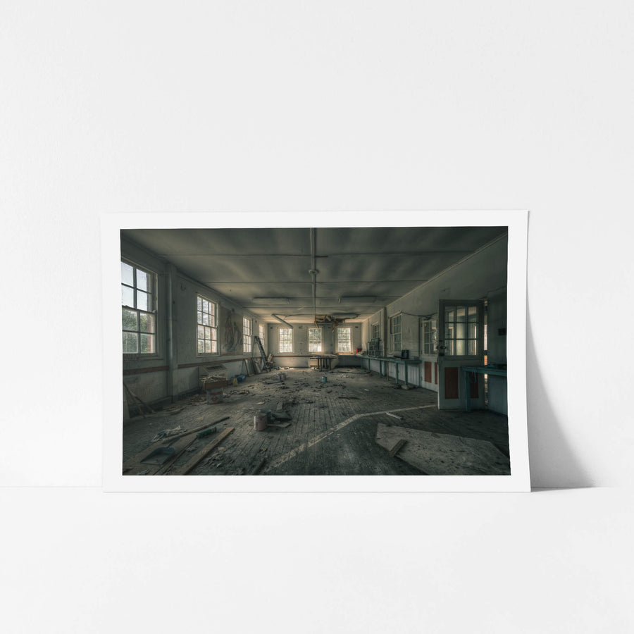 Paint Shop at The Asylum, a large open room with timber floorboards buckled and grey with dust.