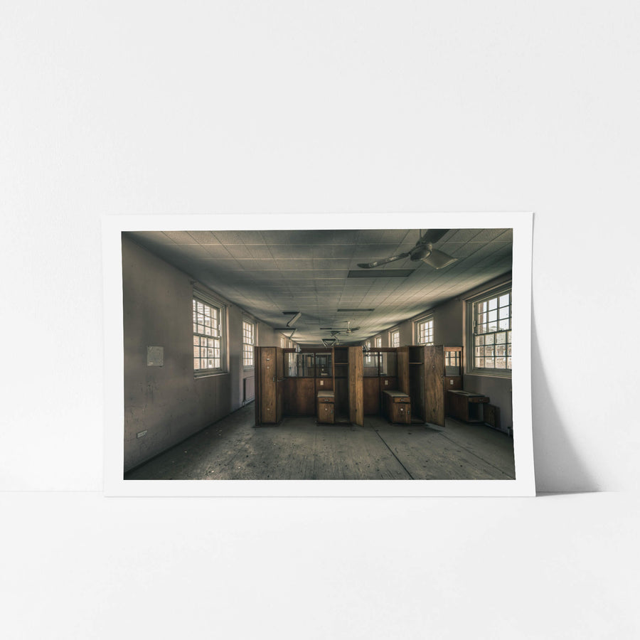 Patient Partitions at The Asylum, timber partitions stand clustered in the centre of a long ward.