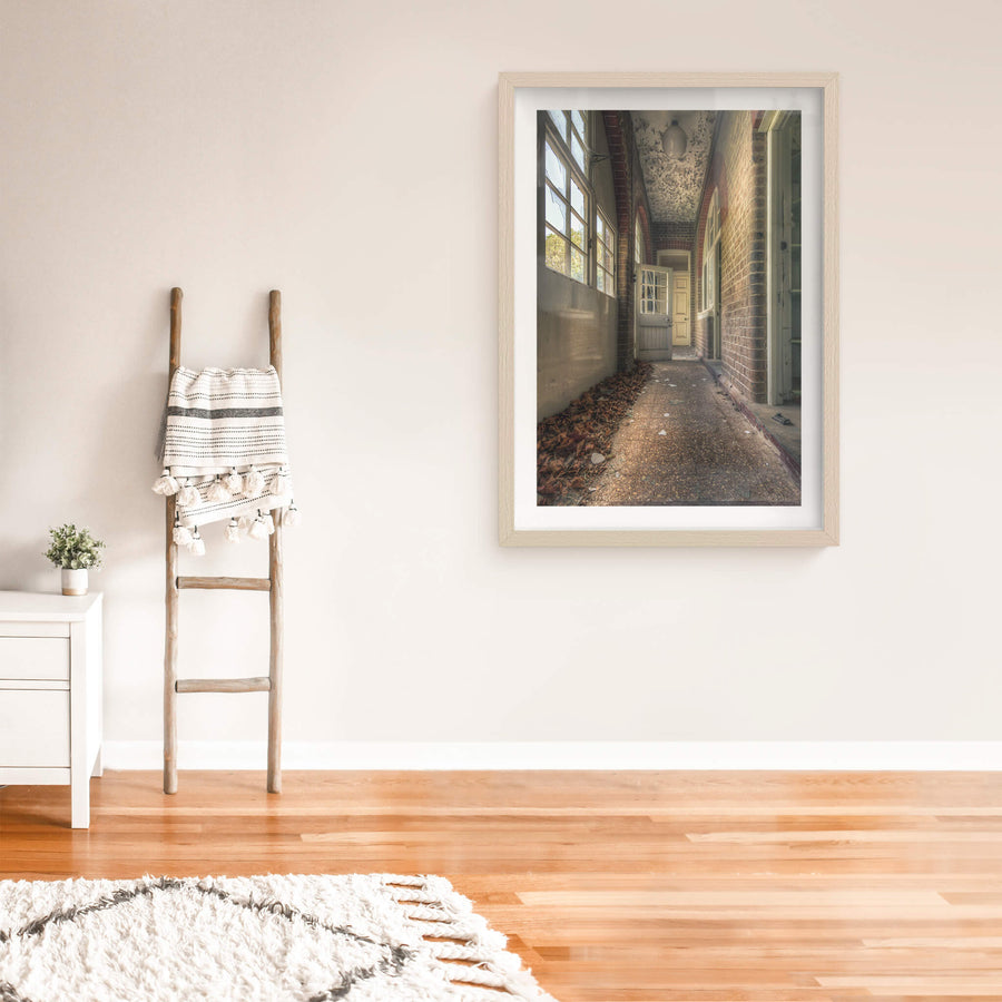 Pebblecrete Pavers at The Asylum, a narrow corridor runs between red brick columns and a rendered half-wall.