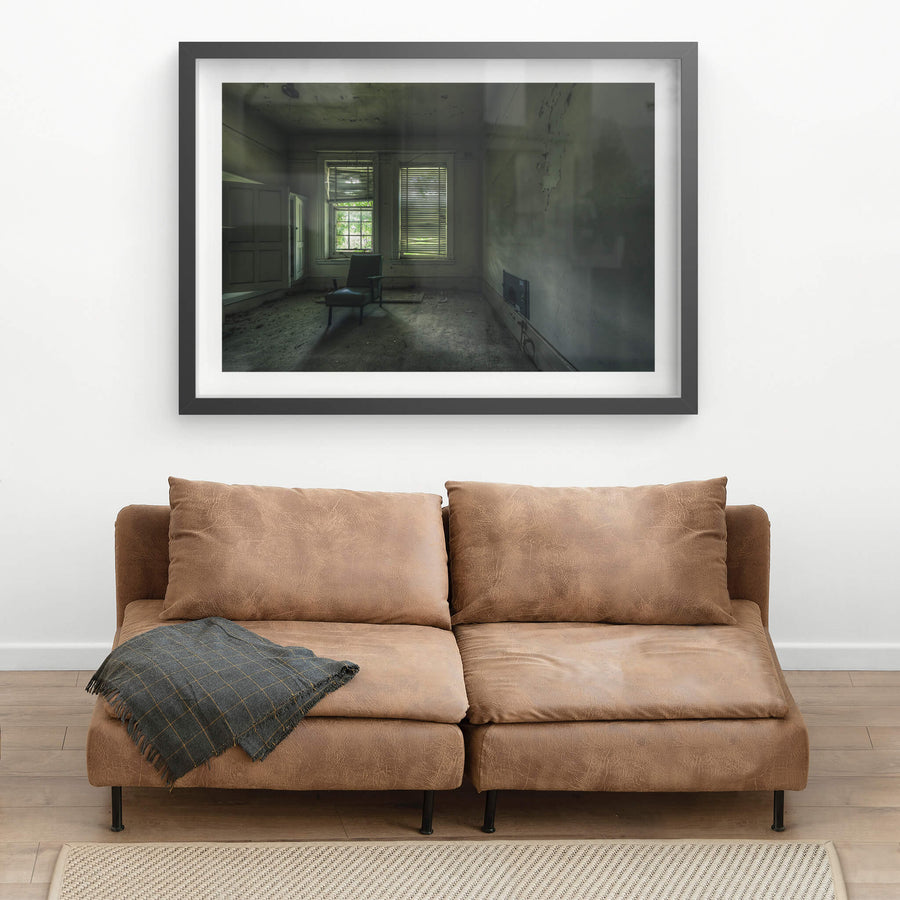 Slots of Light at The Asylum, a single vinyl chair sits near two windows in an otherwise empty room.