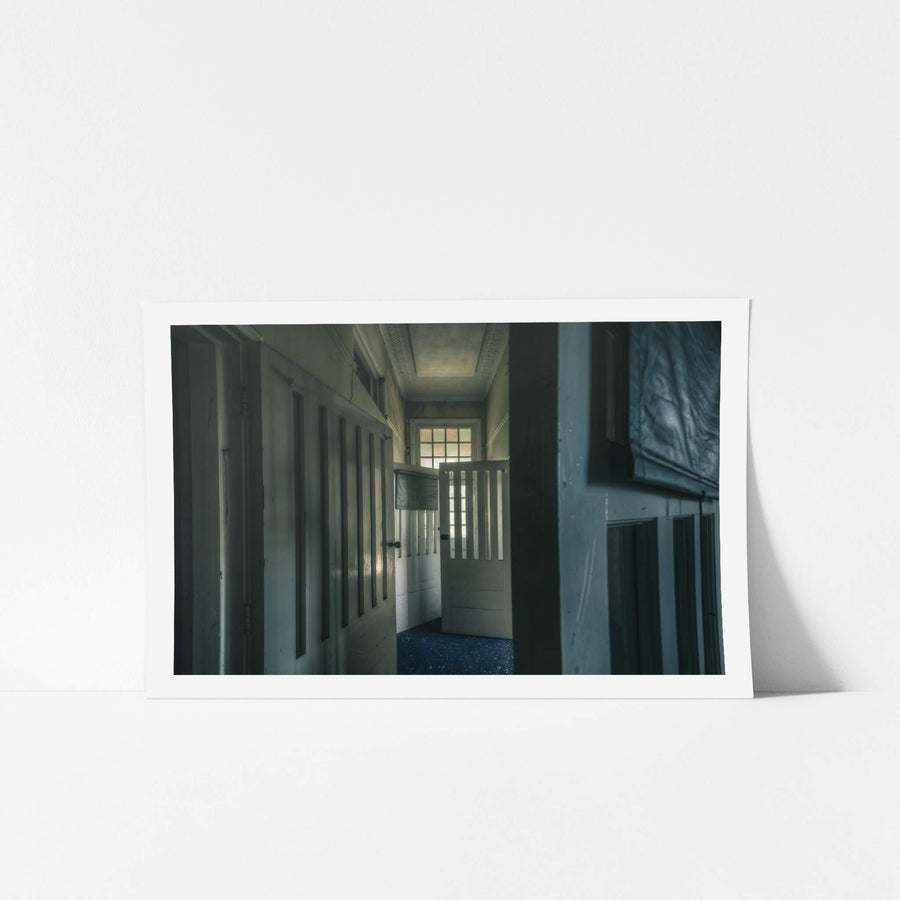 Slotted Doors at The Asylum, a narrow corridor lined with tall timber doors, each cut with vertical slotted openings.
