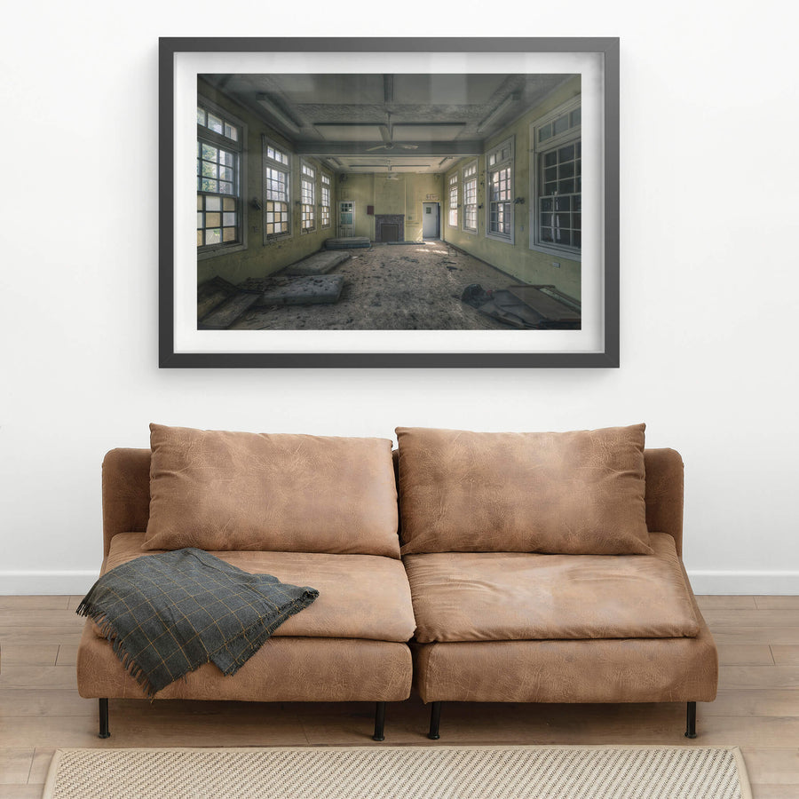Spare Beds at The Asylum, a large common room with pale yellow walls and white-trimmed windows on three sides.