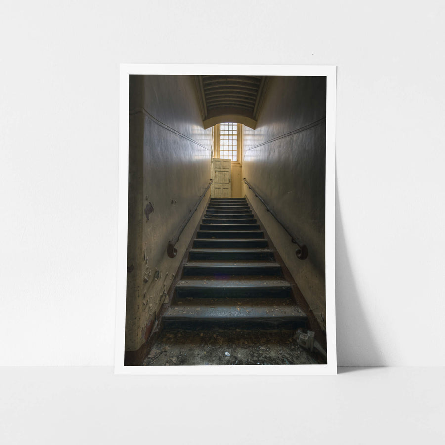 Stairs Up at The Asylum, a narrow stairwell climbs steeply between close walls.
