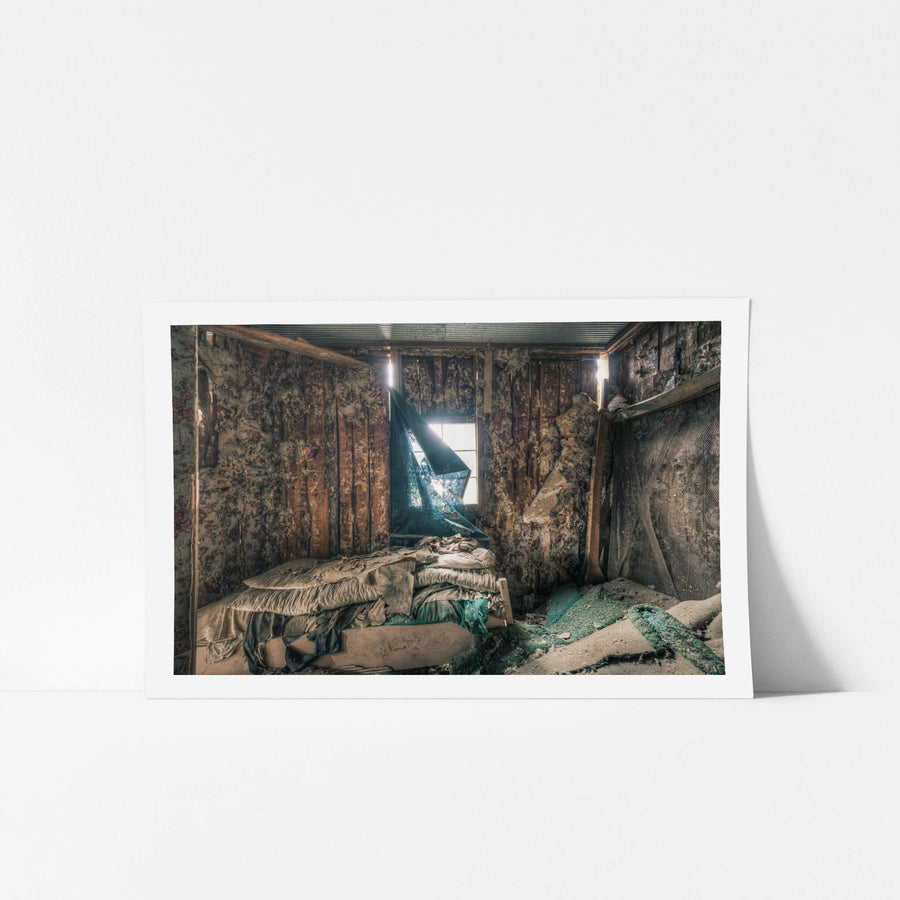 Floral at The Post Office, a torn blue curtain hangs from a window, half-collapsed, letting a shaft of light cut.